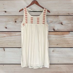 Boutique easel dress babydoll style with rust color embroidery & keyhole back